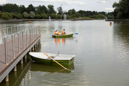 Boat at the pier. Marina with water transport. Boat station on the city lake.の写真素材