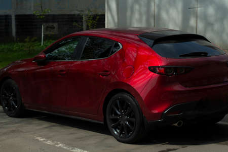 Red car in the parking lot. Sports transport. The car is a glossy coating.の写真素材