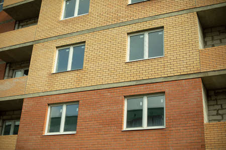 Windows in the new house. Plastic windows are installed in a brick house. New building.の写真素材