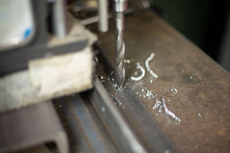 Drill for metal. Drilling machine for making holes in steel. Equipment in a metal workshop.の写真素材