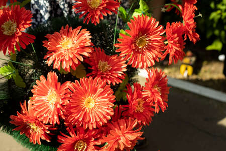 Artificial flowers. Flowers on the monument. A wreath of flowers for the memory of the dead.の写真素材