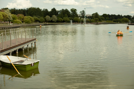 Boat at the pier. Marina with water transport. Boat station on the city lake.の写真素材