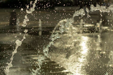 Jets of water from fantan. Freshness of water splashes. A square with a lot of fantasies.の写真素材