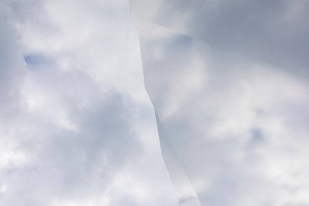 The texture of the sky reflected in the mirror. Clouds distorted by a broken mirror surface. Cracked sky. Cloudy weather.の写真素材