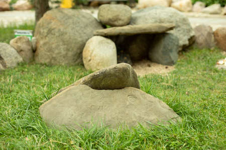 A house made of stones for a turtle in the park. The stones are stacked together on the grass. Landscape decoration with stones of a small yard.の写真素材