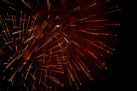 Salute in the sky. Explosion of fireworks in the night sky. Firecrackers flapping sparks in a dark space. Festive fireworks. Background with sparks from burning gunpowder.の写真素材
