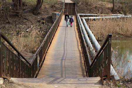 A bridge over the river. A pedestrian bridge over a body of water. It's a good place in the city.の写真素材