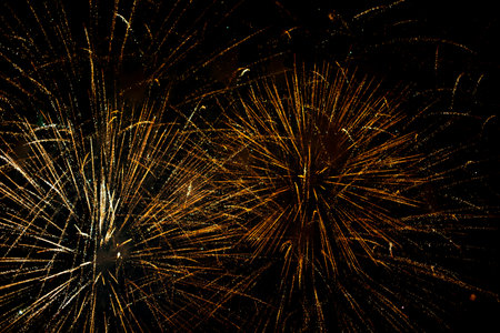 Salute in the sky. Explosion of fireworks in the night sky. Firecrackers flapping sparks in a dark space. Festive fireworks. Background with sparks from burning gunpowder.の写真素材