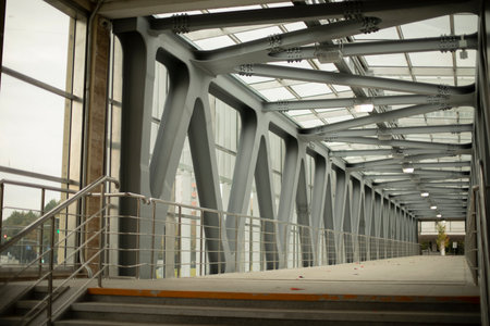 Architecture in the city. Pedestrian crossing over the highway. Steel beams in the tunnel. A strong...