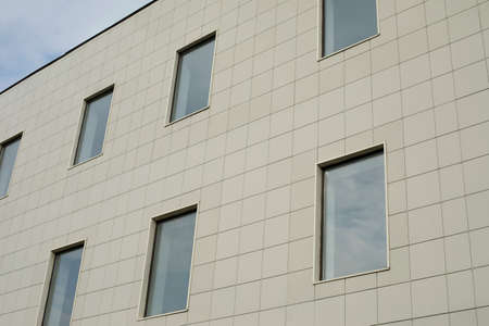 Windows in the office building. Facing panel in modern architecture. Details of urban development.の写真素材