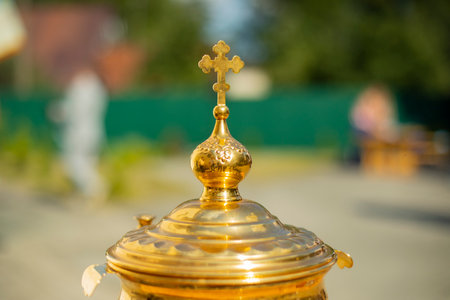Orthodox cross on a gold object. Goldware for religious rites. Details of the Orthodox faith and the Christian religion.の写真素材