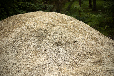 Crushed stone at the construction site. Building material gravel. Small stone for the mound. A bunch of sand with stones.の写真素材