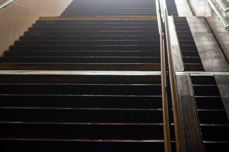 Stairs at the station. Steps to the top. Climbing the stairs. Pedestrian crossing under the track.の写真素材