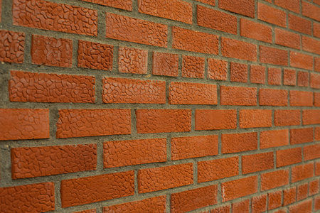 Brick with texture. The wall of red brick is removed on the squint. Cement and stone.
