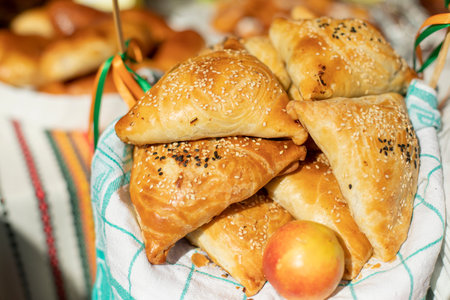 Armenian pastries. Sweet dough. Flour product in sunlight. Buns sprinkled with sesame.
