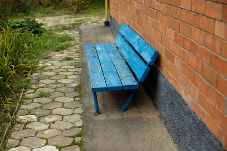 Blue shop made of wood near the wall. A place to relax in the yard. Brick wall.の写真素材