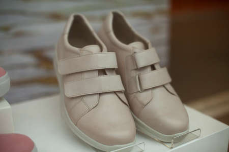 Women's shoes on display. Lightweight shoes without logos. Sale of clothes.の写真素材