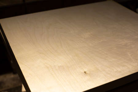 Production of furniture from wood. Plywood in the carpentry workshop. Raw veneer material. Blank from the board.の写真素材