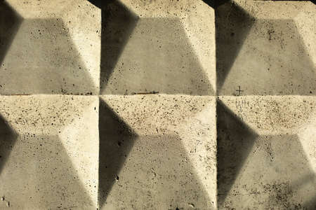 Text of concrete block. Industrial fence in the Soviet Union. Background from a concrete fence. Gray wall. Details of the building.の写真素材