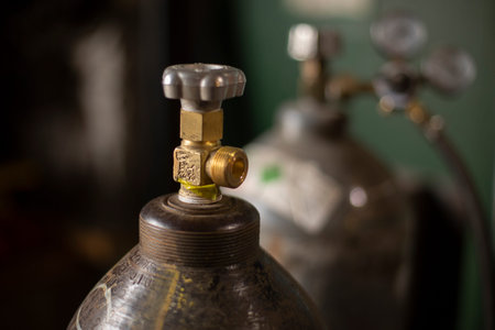 High pressure cylinder. Tank with gas. Valve for pressure adjustment. Gas cylinder in the garage.