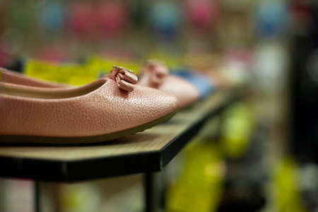 Shoes in the store. Details of the clothing store. Shoes stand in a row.の写真素材