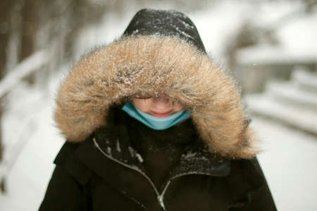 Girl applies powder to her face. Student uses cosmetics. Applying makeup to skin. face of young girl.の写真素材