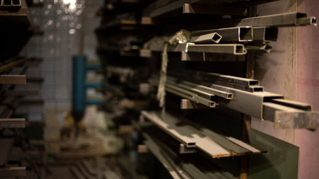 Steel profile on shelves. Metal storage details. Warehouse in shop. metal beams in the room.の写真素材