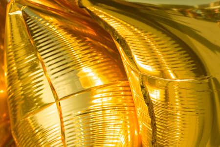 golden balloons. Festive stars filled with gas. bright texture. Details of holiday.の写真素材