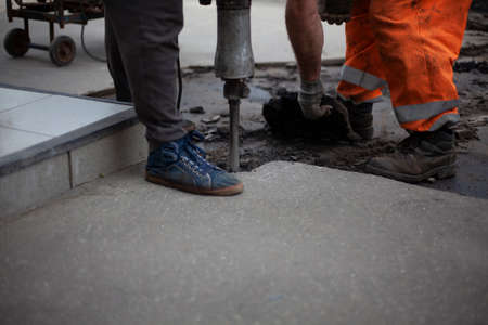 road repair. Installation of curbs on the highway. The workers are working hard.の写真素材