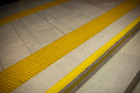 Surface for visually impaired. Yellow limiter for blind. Markings on stairs. Steps in building....
