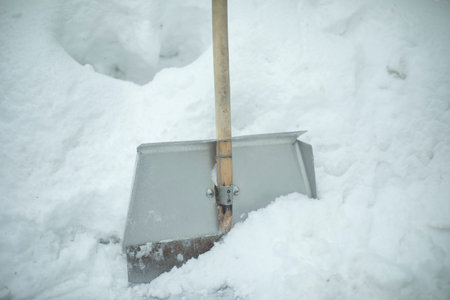 Snow removal. Shovel is stuck in deep snow. track cleaning tool. Details of cleaning area in winter.の写真素材