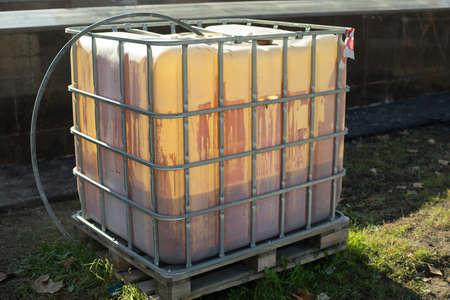 water tank. Canister for storing rainwater. Capacity for hundred liters of liquid. Object in garden. water system.の写真素材