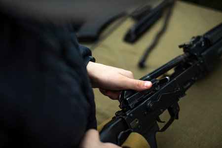 Children learn to shoot in Russia. Assembly of automatic weapons. Lesson in military training....