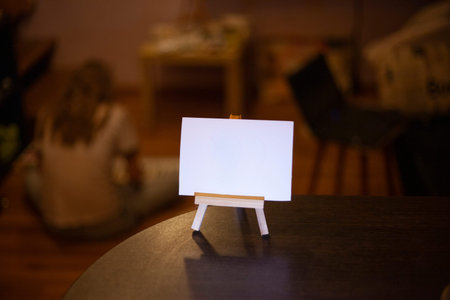 White sign for inscription. Small blank poster mounted on wood molar. Workpiece for inserting text...