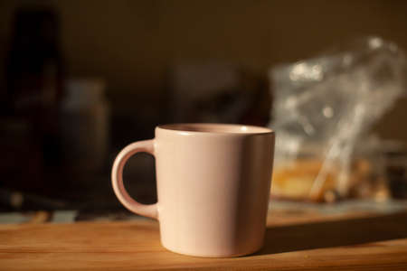 cup on table. kitchen details. Light on dishes. Morning drink. Tea for breakfast.の写真素材