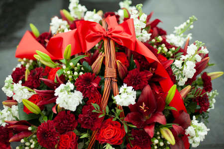 flowers on memorial. Details of funeral decoration. Bouquet of flowers on grave. Mourning ceremony.の写真素材