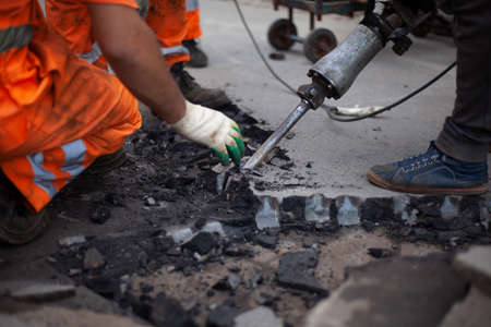 road repair. Installation of curbs on the highway. The workers are working hard.の写真素材