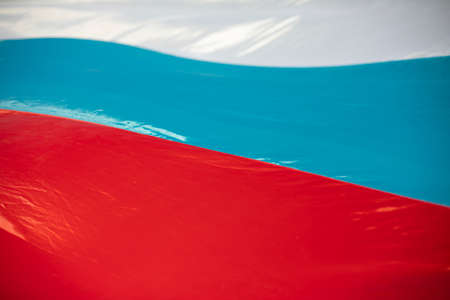 Textured fabric in wind. Flag of Russia fabric. Wind blowing on surface of light fabric. White, blue and red.の写真素材