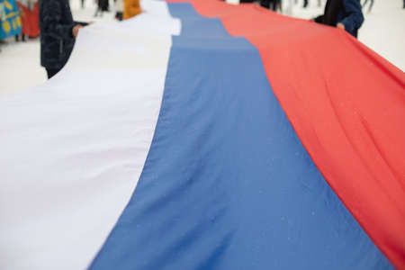 Flag of Russia. People hold fabric. Lot of people at rally in support of policies of government and president.の写真素材