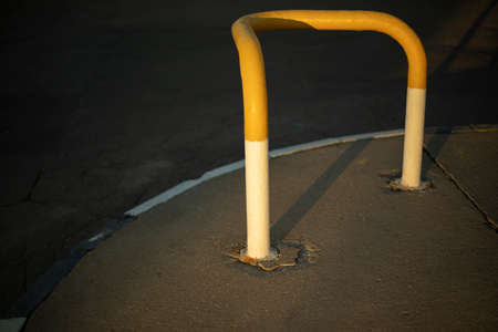 Parking bollard. Fence to block passage. Yellow paint on steel pipe.の写真素材