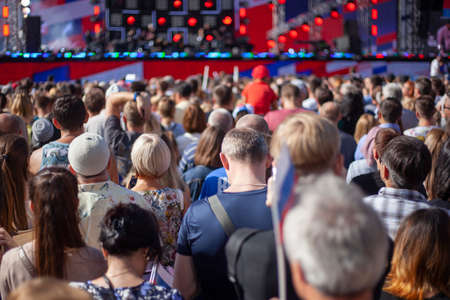 A lot of people at a big event. People at the concert. A crowd of people protesting on the street. Russians gathered at a rally under the command of the authorities. Old and young people listen to a speech.の写真素材