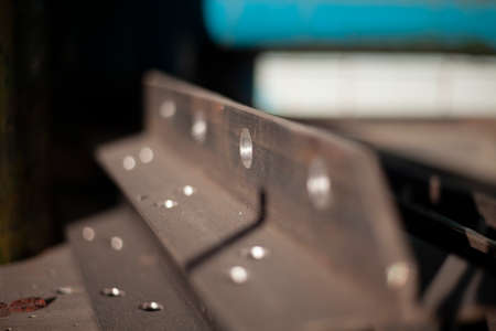 Holes in steel from drilling. metal blank. Steel profile is drilled with drill in workshop. iron product. Holes for fastening structure.の写真素材