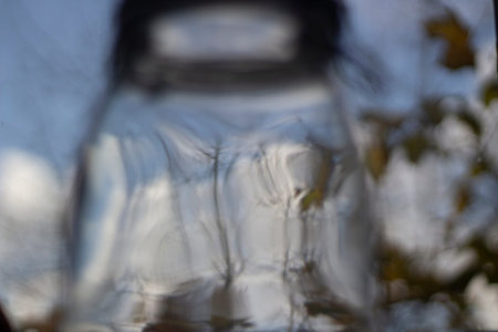 glass jar on windowsill. Storage capacity for ingredients. Utensils in kitchen. cutlery. Lid of glass jar.の写真素材