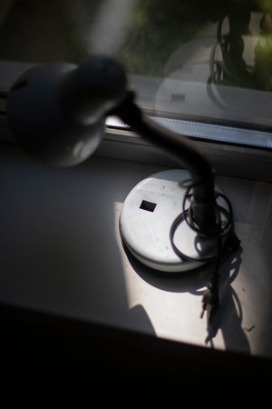 Electric plug and socket on the windowsill. Selective focus.の写真素材