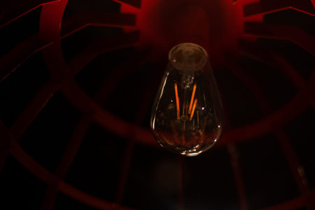 Light bulb in the interior. Light bulb in a dark room. Interior lighting of the room. Lighting in...