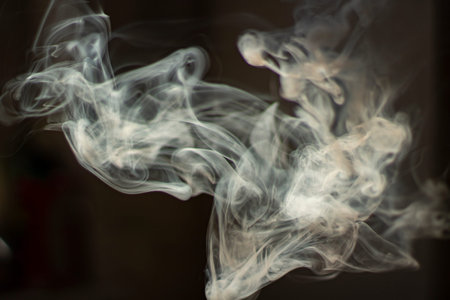 Smoke in natural light. Tobacco smoke fills the air. Clubs of steam in space. The process of smoke...