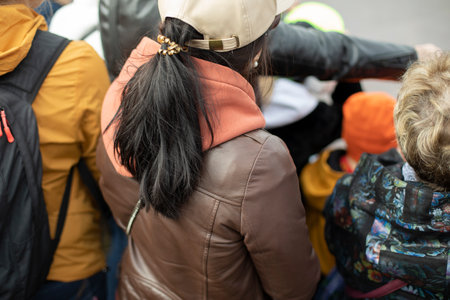 Lot of people watch show on street. People's backs. street performance. Details of city festival.の写真素材