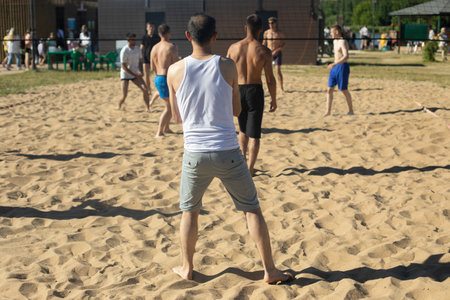 Playing volleyball on beach. Sports on shore. Sand and ball.の写真素材