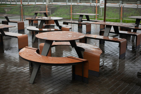 Tables of street restaurant. rain in the city. Empty spaces.