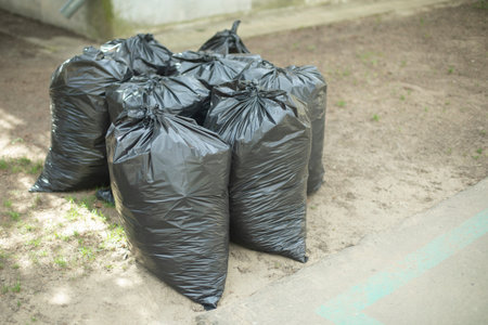 Black trash bags. Waste bags. Cleaning on territory. cleaning details.